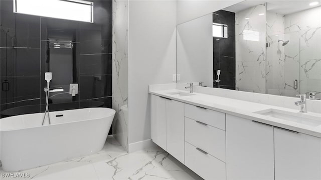 full bathroom with double vanity, marble finish floor, a marble finish shower, and a sink