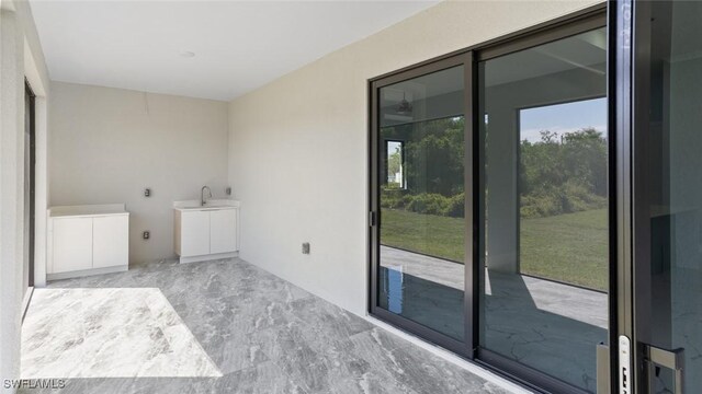 clothes washing area with marble finish floor