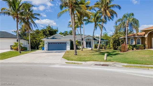 single story home featuring a garage and a front yard