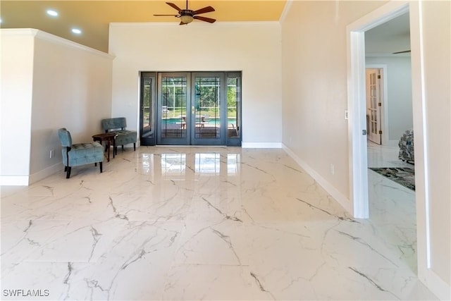 interior space featuring french doors, ceiling fan, crown molding, and a high ceiling