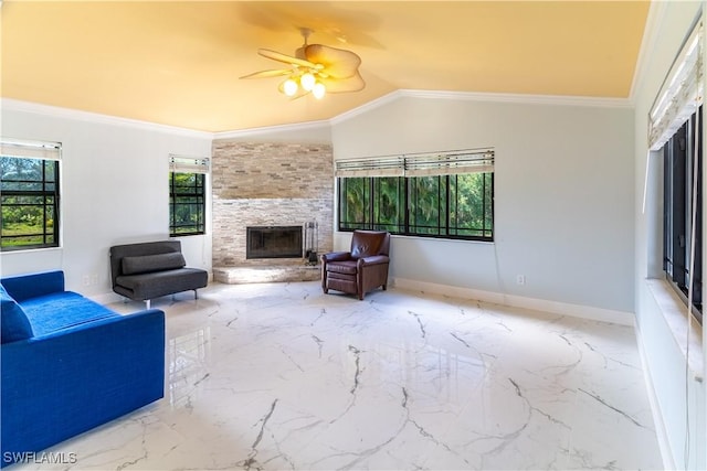 living room featuring a fireplace, ornamental molding, ceiling fan, and vaulted ceiling