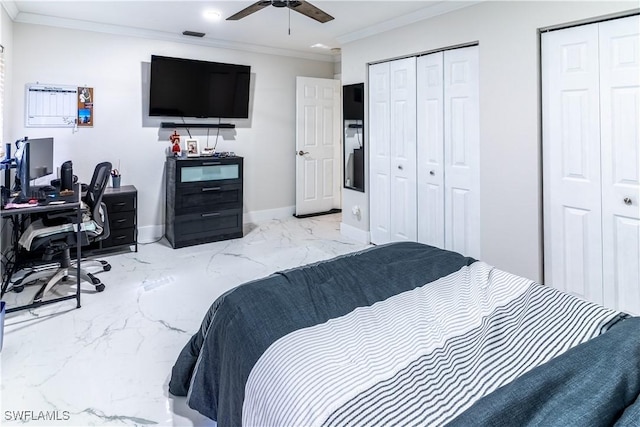 bedroom with ornamental molding, two closets, and ceiling fan