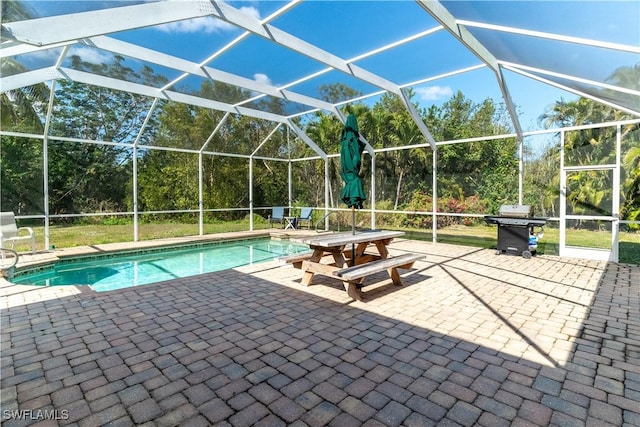 view of swimming pool featuring a grill, a patio, and glass enclosure