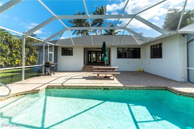 view of pool with a patio, a grill, and glass enclosure