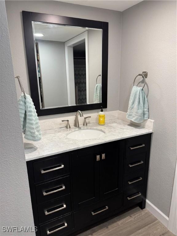 bathroom featuring vanity and wood-type flooring