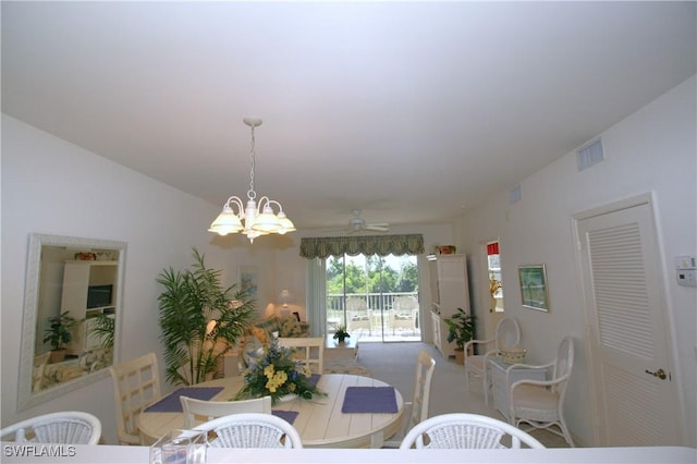 dining area featuring vaulted ceiling and ceiling fan with notable chandelier