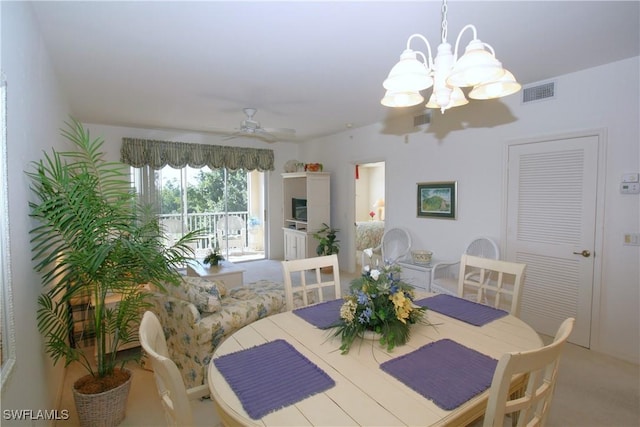 dining space with ceiling fan and carpet floors