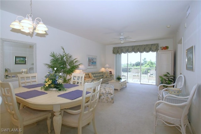 dining room featuring light carpet and ceiling fan with notable chandelier