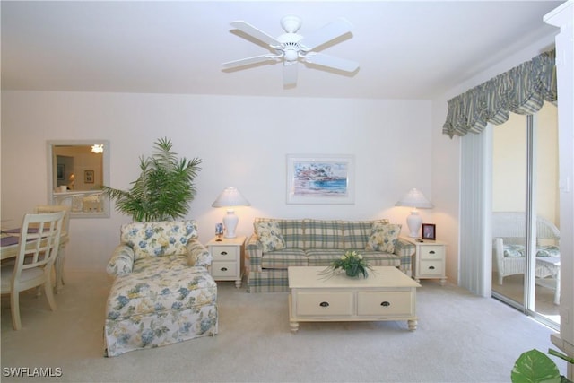 carpeted living room with ceiling fan