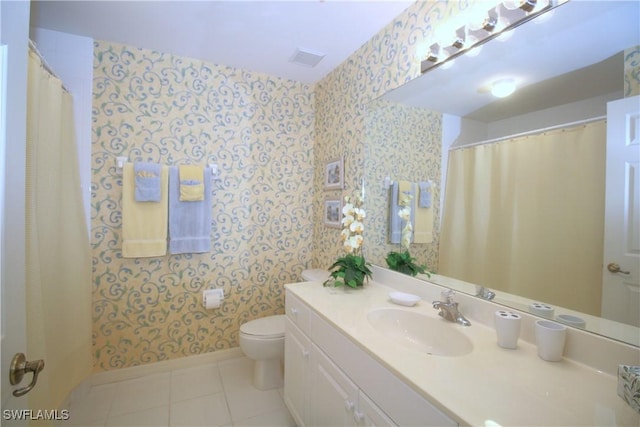 bathroom with tile patterned floors, toilet, and vanity