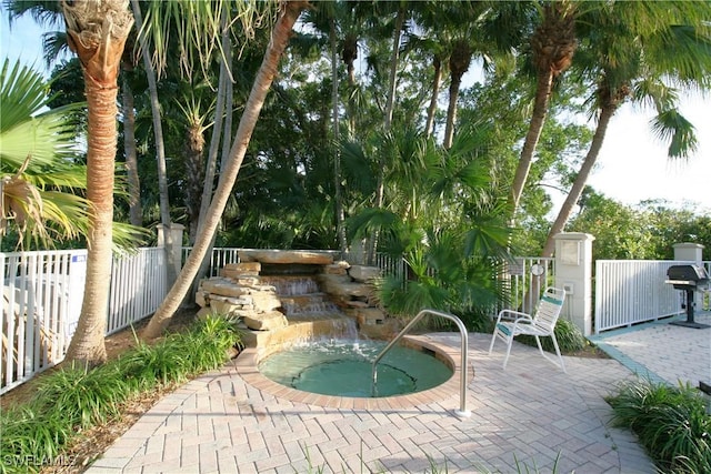 view of swimming pool featuring a patio area and a community hot tub