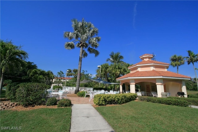 view of home's community featuring a patio and a lawn