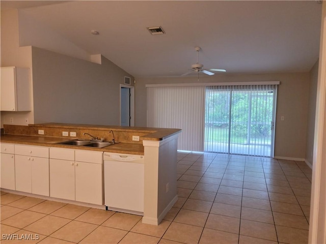 kitchen featuring sink, dishwasher, white cabinetry, light tile patterned flooring, and vaulted ceiling