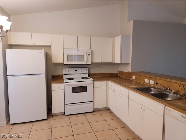 kitchen with sink, white appliances, light tile patterned floors, and white cabinets