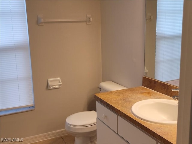 bathroom featuring vanity, tile patterned flooring, and toilet