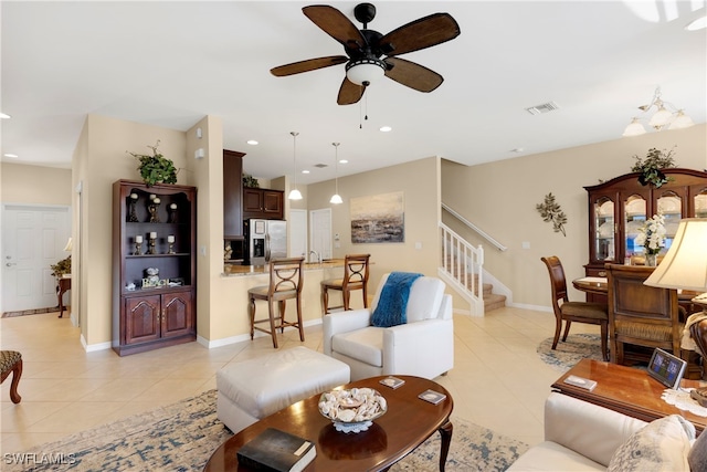 tiled living room with ceiling fan