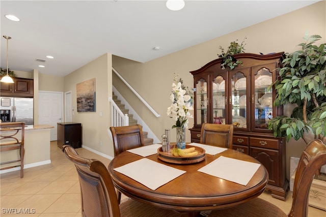 dining space featuring light tile patterned floors