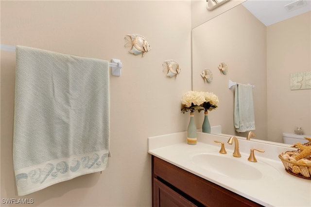 bathroom featuring vanity and toilet