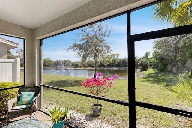 unfurnished sunroom with a water view