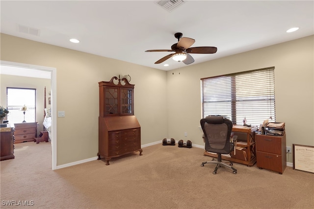 office space featuring ceiling fan and light colored carpet