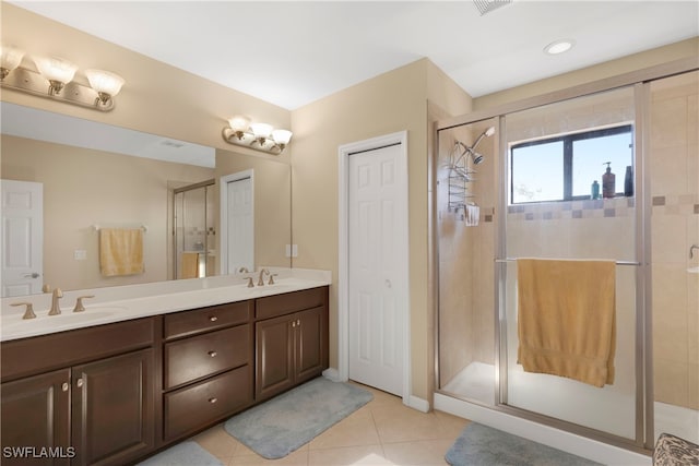 bathroom with vanity, a shower with door, and tile patterned floors