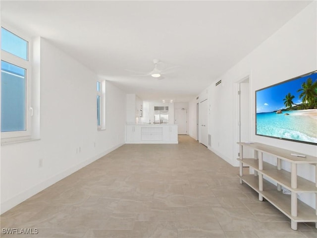 unfurnished living room featuring ceiling fan