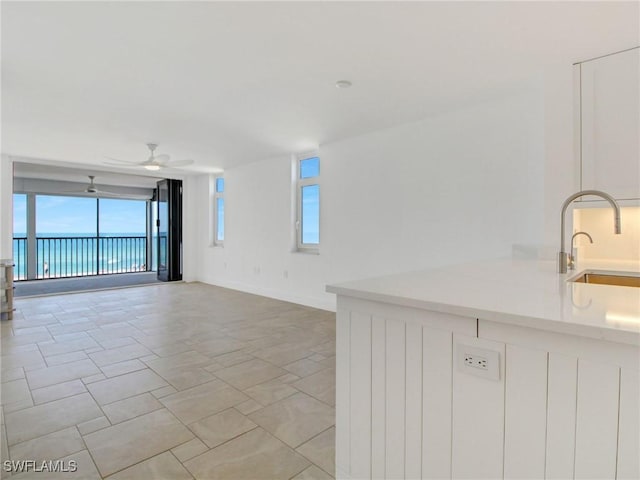 unfurnished room featuring sink and ceiling fan