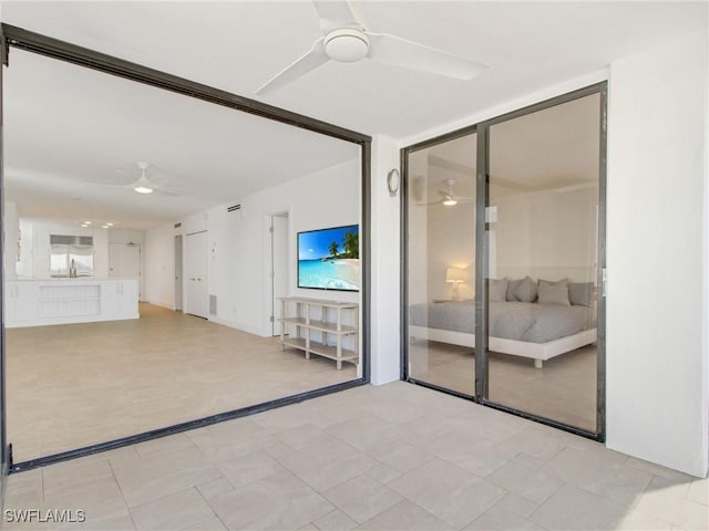 unfurnished living room with ceiling fan