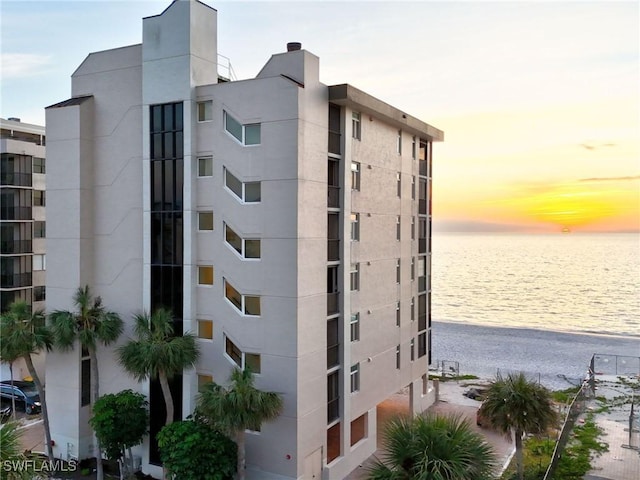 outdoor building at dusk with a water view and a beach view