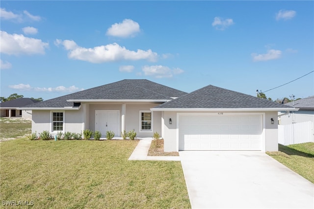 view of front of house featuring a garage and a front lawn