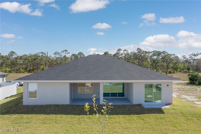 back of property with a patio area and a lawn