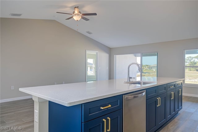 kitchen with lofted ceiling, sink, dishwasher, a center island with sink, and blue cabinets