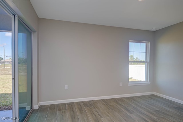 empty room with hardwood / wood-style floors