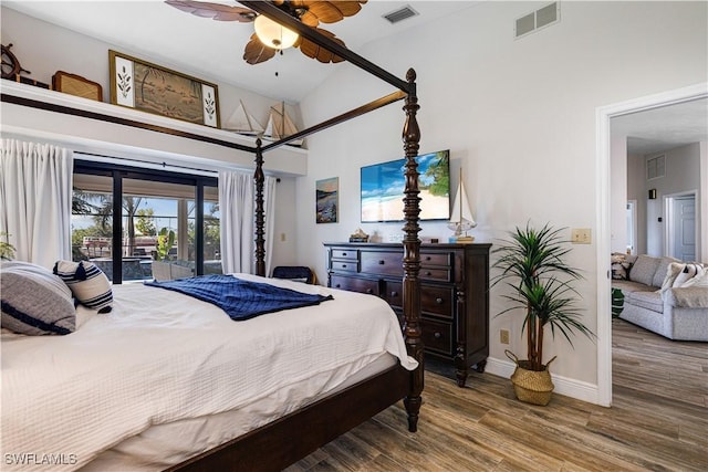 bedroom with hardwood / wood-style flooring, ceiling fan, access to exterior, and high vaulted ceiling