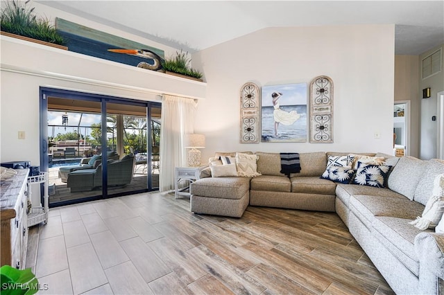 living room featuring high vaulted ceiling