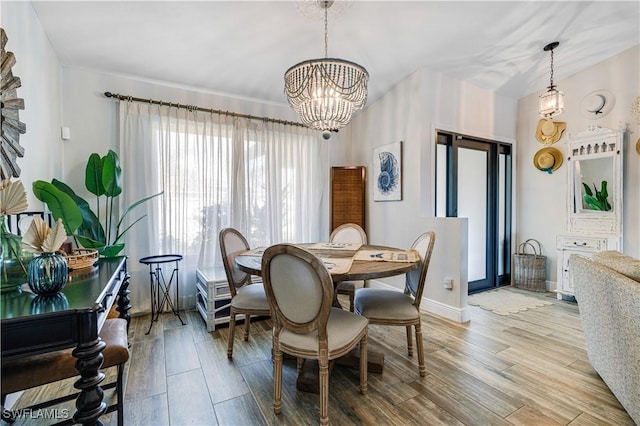 dining area featuring light hardwood / wood-style flooring and a notable chandelier