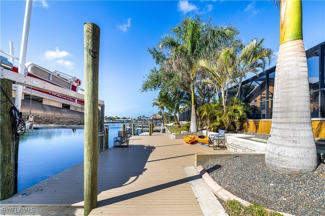 dock area with a water view and a lanai