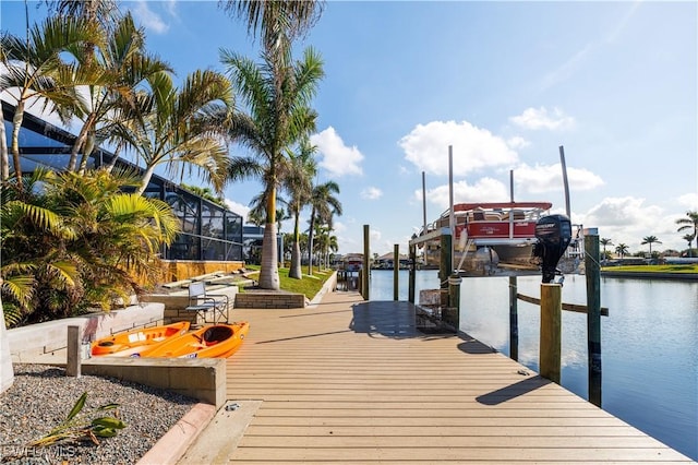 view of dock with a water view and glass enclosure