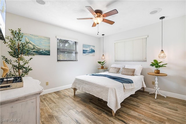 bedroom featuring wood-type flooring and ceiling fan