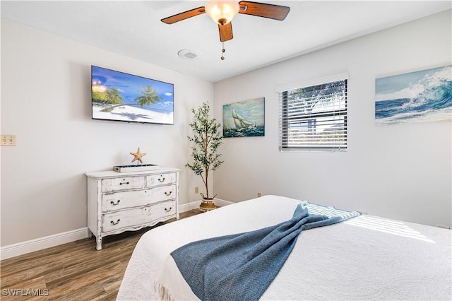 bedroom with ceiling fan and dark hardwood / wood-style floors