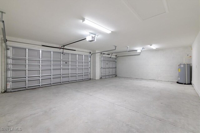 garage featuring a garage door opener and water heater