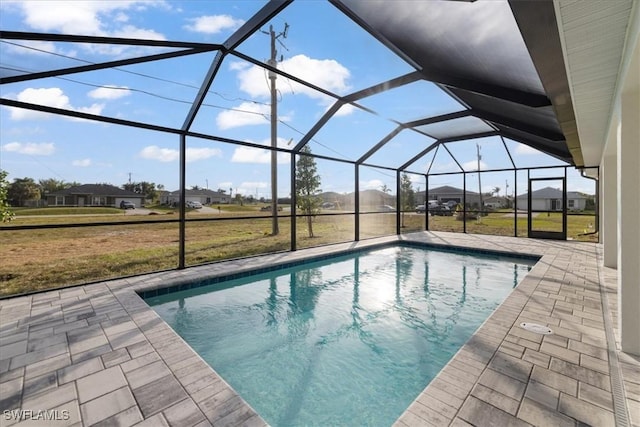 view of pool with a patio, a lanai, and a lawn