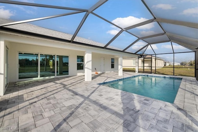 view of pool featuring a patio area and glass enclosure