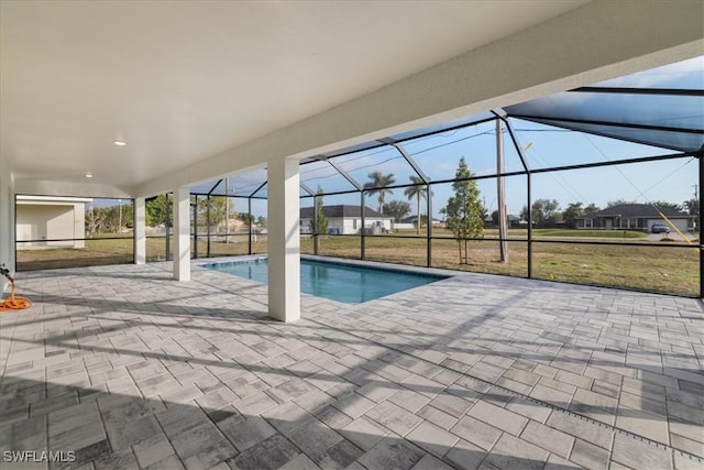 view of swimming pool featuring a yard, a lanai, and a patio area