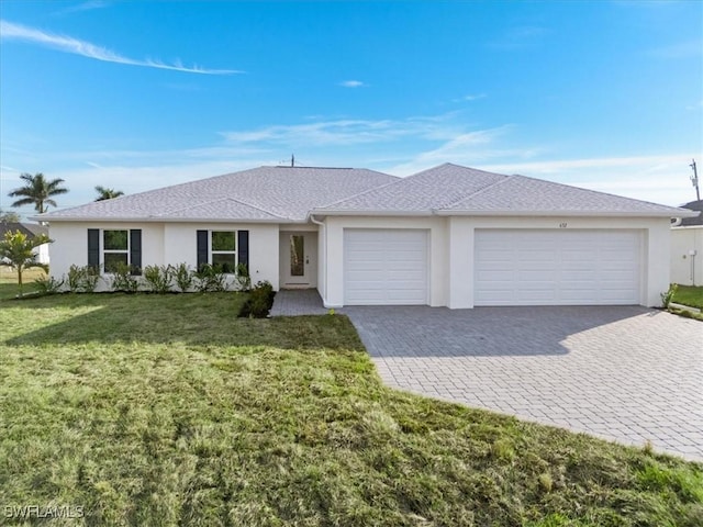 ranch-style home with a garage and a front lawn