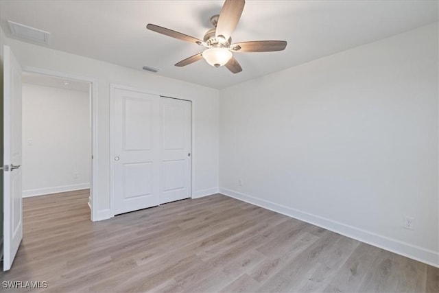 unfurnished bedroom with a closet, ceiling fan, and light hardwood / wood-style flooring