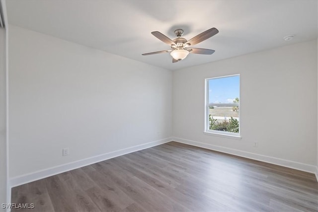 spare room featuring dark hardwood / wood-style floors and ceiling fan