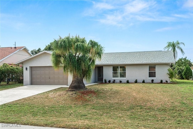 single story home featuring a garage and a front lawn