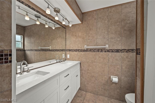 bathroom featuring tile walls, vanity, tile patterned flooring, and toilet