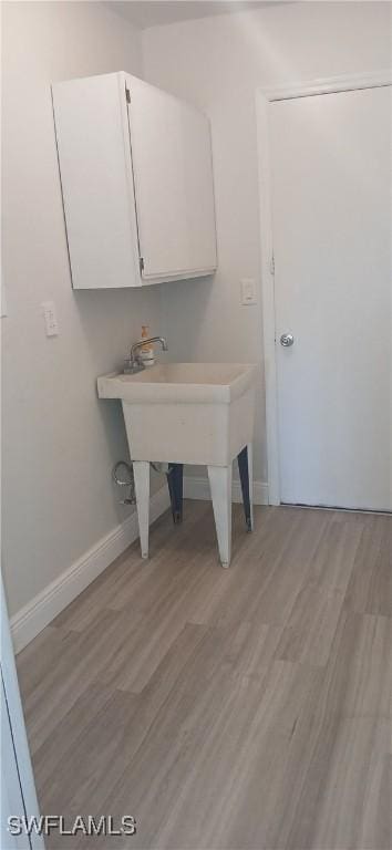 laundry room with light wood-type flooring